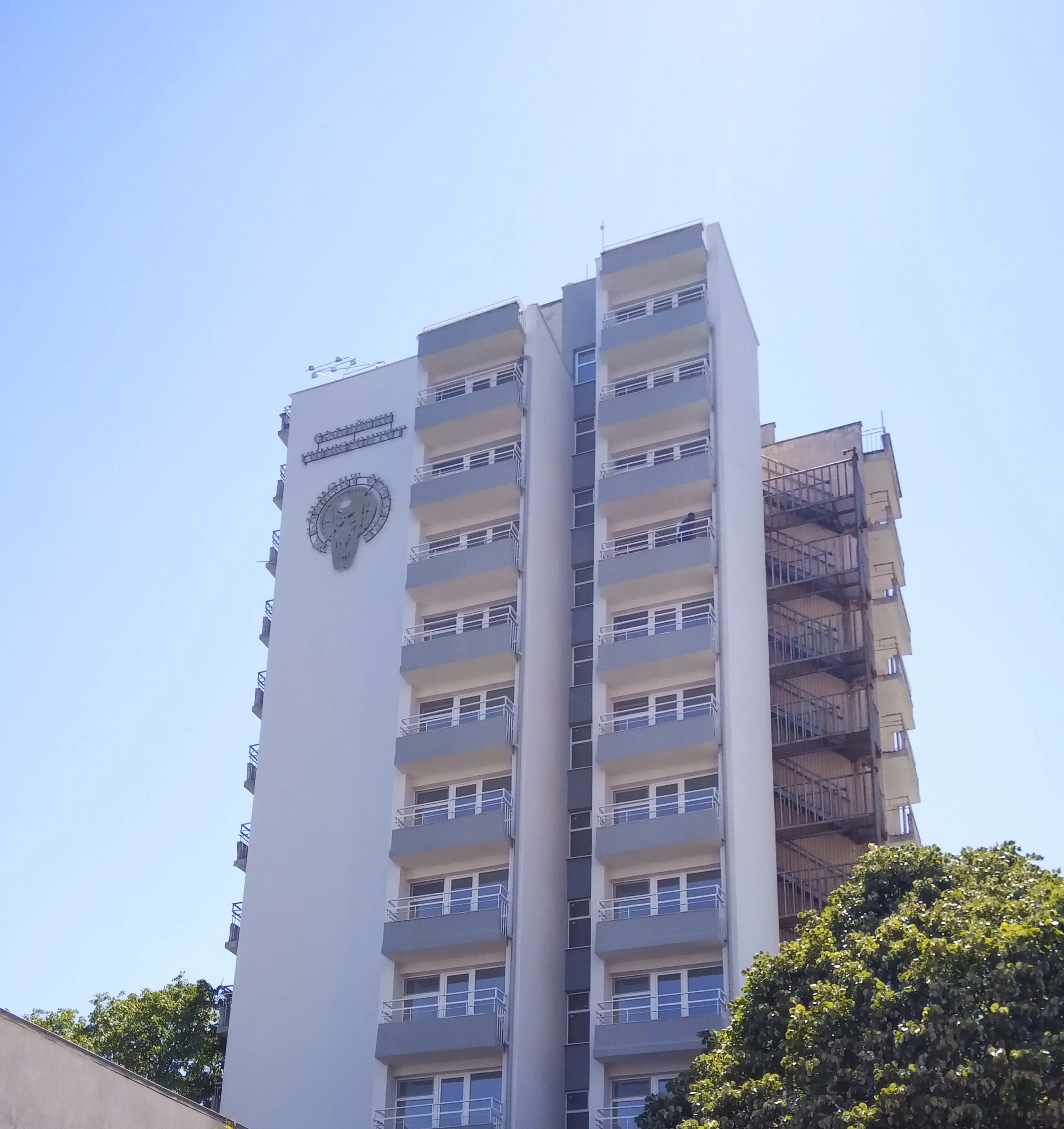 Снимка на обновената фасада на Творчески дом Китен на Софийски университет. Височинен монтаж на указателна табела