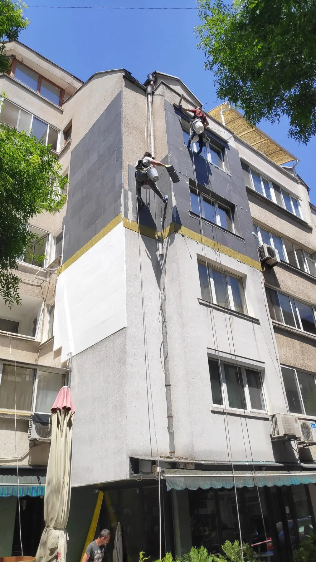 Полагане на външна топлоизолация от строителни алпинисти. Работа на труднодостъпно място